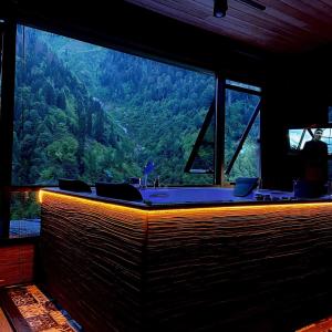 a room with a tub with a view of a mountain at Ayder Villa de Pelit Hotel in Ayder Yaylasi