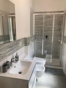 a bathroom with a sink and a toilet and a shower at Mati's House in Bellagio +8 photos