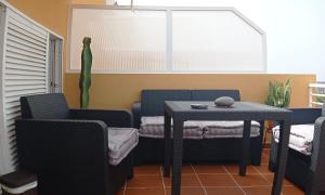 a room with a table and chairs and a table and a window at Apto Magec in Puerto de Santiago +29 photos