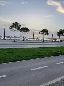 an empty road with trees on the side of the road at Appartamento lungomare Bianca in Vlorë +2 photos