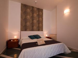 Postel nebo postele na pokoji v ubytování Hotel Metropol