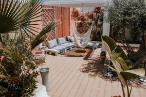 a patio with a hammock and a swing at Casa Morgados - Grândola Guesthouse in Grândola