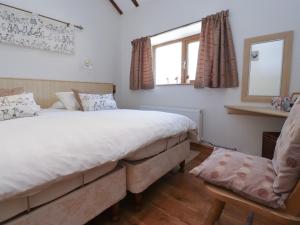 a bedroom with a bed and a window and a chair at The Proven House in Preston