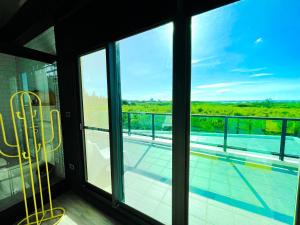 a room with a balcony with a view of a pool at Noah's Ark Homestay in Huxi
