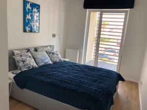 Posteľ alebo postele v izbe v ubytovaní Apartament Beluga