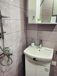 a bathroom with a white sink and a mirror at Къща за гости Станеви in Ribarica +41 photos
