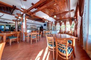 a dining room with wooden tables and chairs at Hotel Kokiche in Sunny Beach