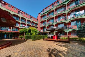 a large apartment building with a cobblestone street at Hotel Kokiche in Sunny Beach