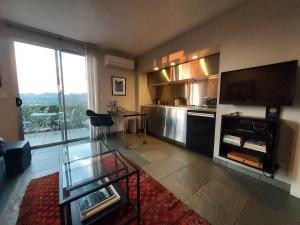 a living room with a large kitchen with a large window at Silver Box Beverly Hills in Los Angeles