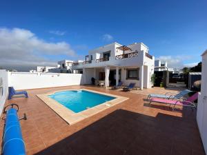 una villa con piscina frente a una casa en Varadero Nauplius, en Playa Blanca