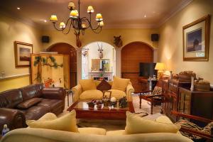 a living room with a couch and a table at Auberge de Courtrai in Paarl