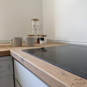 a kitchen counter with three bowls on top of it at Amelia y Aurelio, casa de peregrinos in Mellid