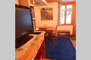 a living room with a large flat screen tv at Olle and Maria's B&B- apartment in Gimmelwald