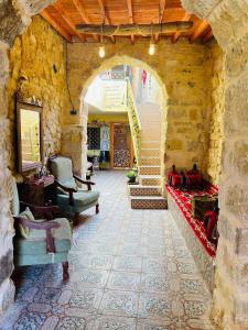 a building with an archway with chairs and stairs at Dana Gate Lodge in Dana