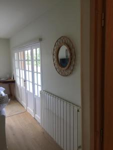 einen Flur mit einem Spiegel an der Wand und einer Tür in der Unterkunft Ambiance Seine - appartement 46m2 terrasse - Hortensia in Thomery