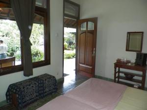 Säng eller sängar i ett rum på Rumah Sawah