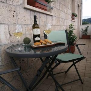 a table with a bottle of wine and two glasses at Umbriahouse in Terni