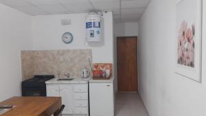 a kitchen with a stove and a white refrigerator at DEPRTAMENTO DONOVAN II in Resistencia