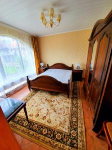 a bedroom with a large bed and a rug at Brīvdienu mājas in Jūrmala