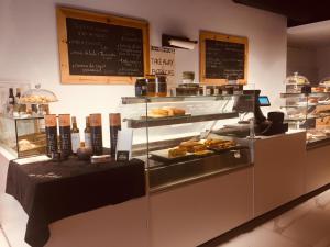 a bakery with a display case with pastries at Douro - A Casinha da Ana in Vila Real