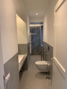 a bathroom with a toilet and a sink and a shower at Appartamenti Marina Corta in Lipari