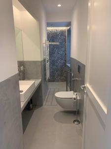 a bathroom with a toilet and a sink and a shower at Appartamenti Marina Corta in Lipari +19 photos