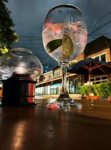 a wine glass with a lime in it sitting on a table at Hotel Zona G in Bogotá