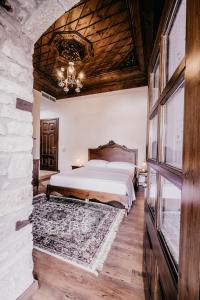 a bedroom with a bed and a stone wall at Beratino Hotel in Berat