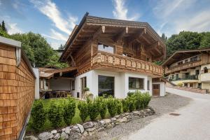 a wooden house with a wooden roof at Naturlodge Tirol - Naturverbunden im Zillertal in Fügen