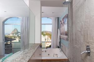 a bathroom with a bath tub and a window at Santa Vista Rio in Rio de Janeiro +56 photos