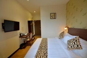 Postel nebo postele na pokoji v ubytování Asiana Hotel + 3 fotografie