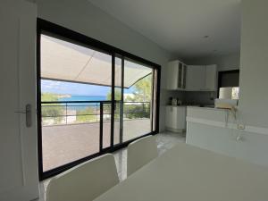 a kitchen with a large window with a view of the ocean at TarracoHomes, TH142 Villa Vista Alegre in Tarragona