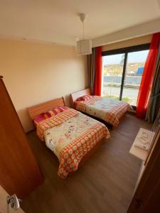 three beds in a room with a window at Bo Islands villa in El Alamein