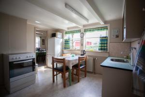 a small kitchen with a table and chairs in it at Cozy house in the idyllic village of Haldórsvík in Haldarsvík +14 photos