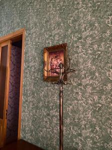 a lamp in a room with a wall at Guest House Eli in Kutaisi