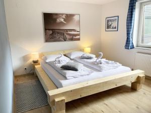 a bedroom with a wooden bed in a room at Apartment Bebette - 1 Bedroom- Austrian Alpine Getaways in Winklerdörfl