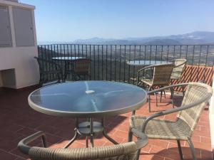 a table and chairs on a balcony with a view at “Sa Scala” Bed&Terrace in Baunei