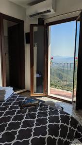 a bedroom with a bed with a view of a balcony at “Sa Scala” Bed&Terrace in Baunei