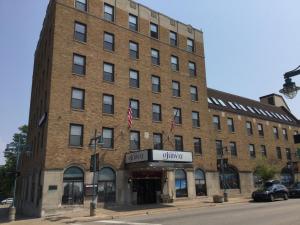 a large brick building on the corner of a street at The Hotel Ojibway, Trademark Collection by Wyndham in Sault Ste. Marie