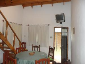 a dining room with a table and a tv on the wall at GRIMALDI in Colón