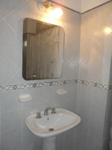 a bathroom with a sink and a mirror at GRIMALDI in Colón +22 photos