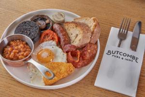 a plate of breakfast food with eggs sausage beans and toast at Prince of Burford in Burford