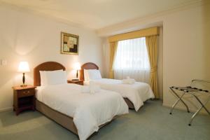 Llit o llits en una habitació de Royal Woods Resort
