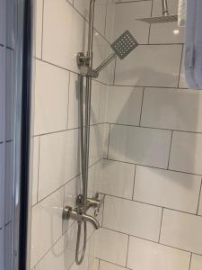 a shower in a bathroom with a glass door at Trivelles Regency, Nottingham in Nottingham