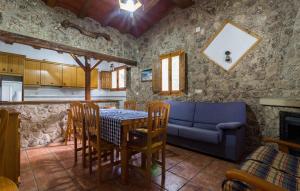 a kitchen and dining room with a table and a couch at Casas Rurales Los Enebros Nerpio in Nerpio