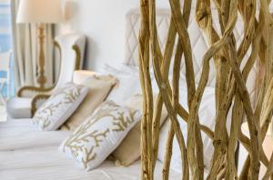 a bedroom with a bed with white sheets and pillows at Gallery Luxury Suites & Rooms-Only Adults in Split