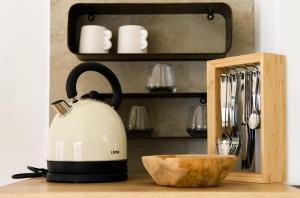 a tea kettle sitting on a counter next to a bowl at Gallery Luxury Suites & Rooms-Only Adults in Split