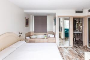 a bedroom with a bed and a bath tub at Hotel Palacio del Mar in Santander