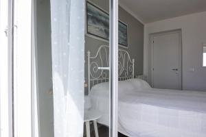 a bedroom with a white bed and a table at MaRea in Lerici