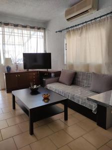 a living room with a couch and a coffee table at Aquarius Hotel in Fourka